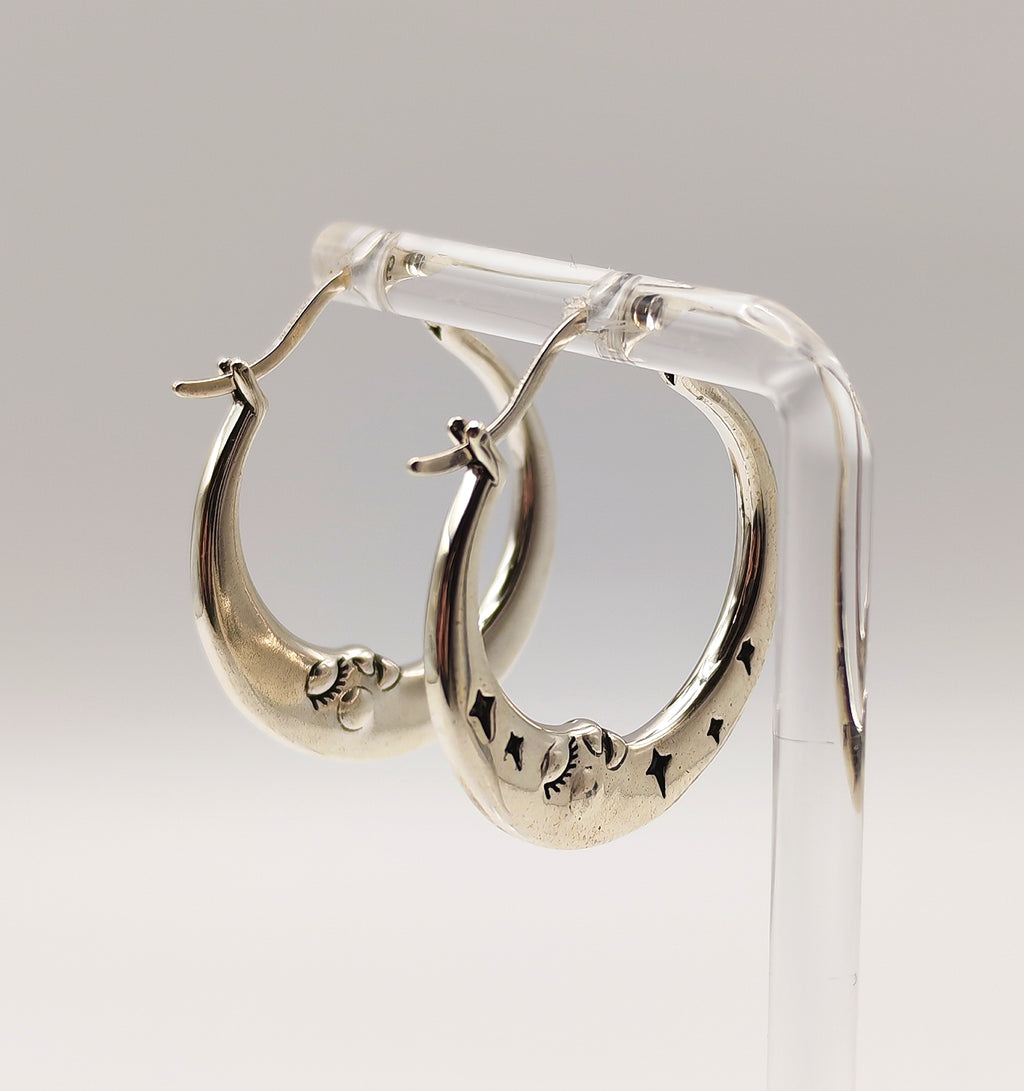 Sterling silver half moon hoop earrings side view showing moon face details.