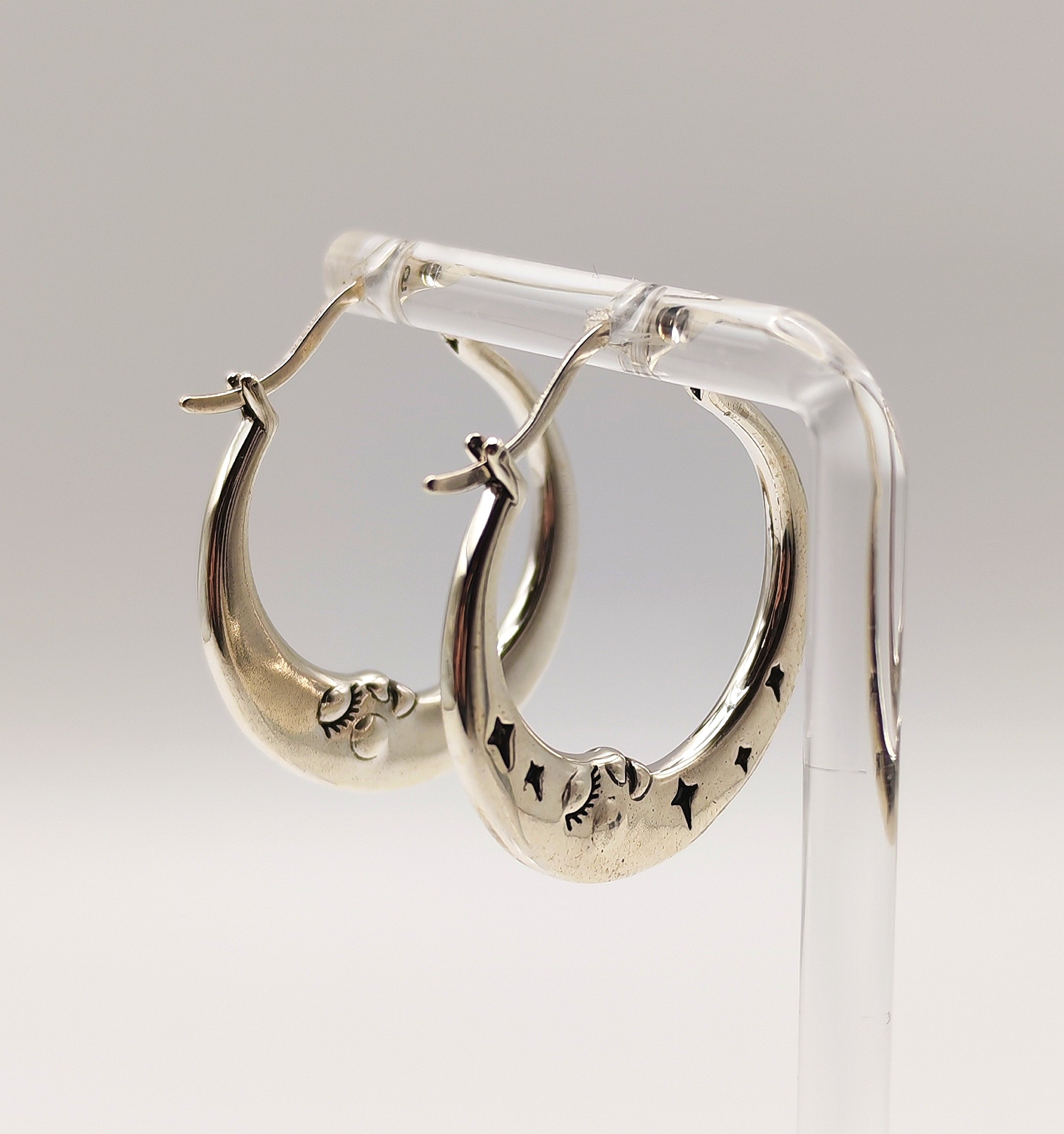 Sterling silver half moon hoop earrings side view showing moon face details.