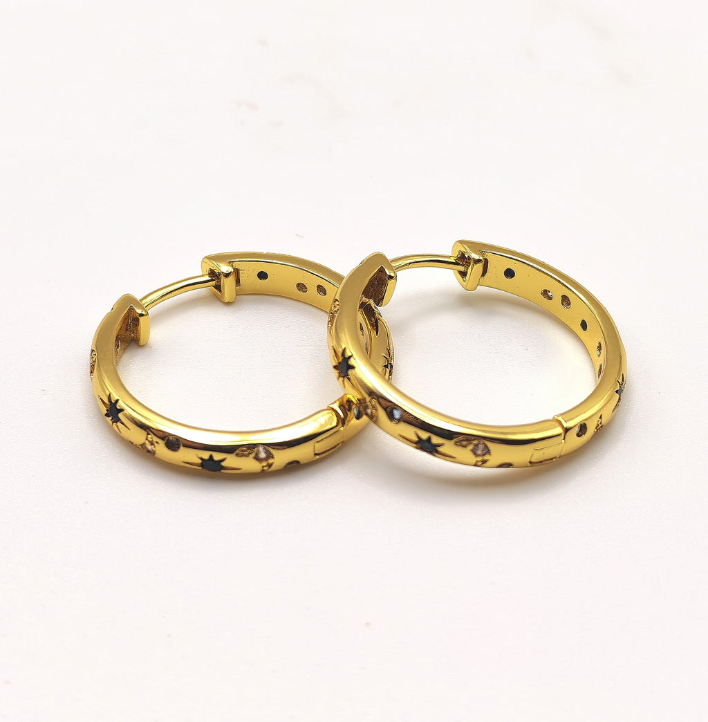 18ct gold plated sterling silver hoop earrings with blue and white zirconia's displayed on a white background.