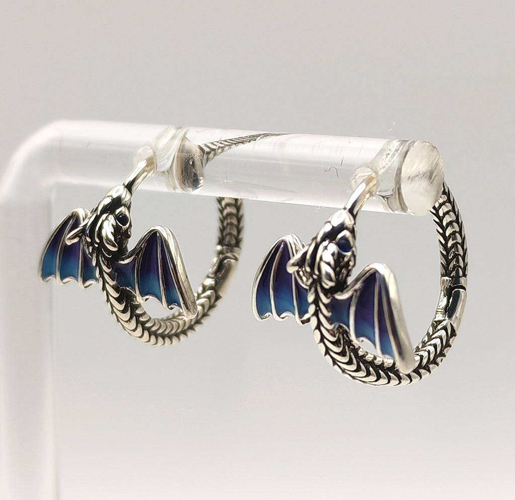 Side view of silver dragon hoop earring highlighting curved tail and wing enamel