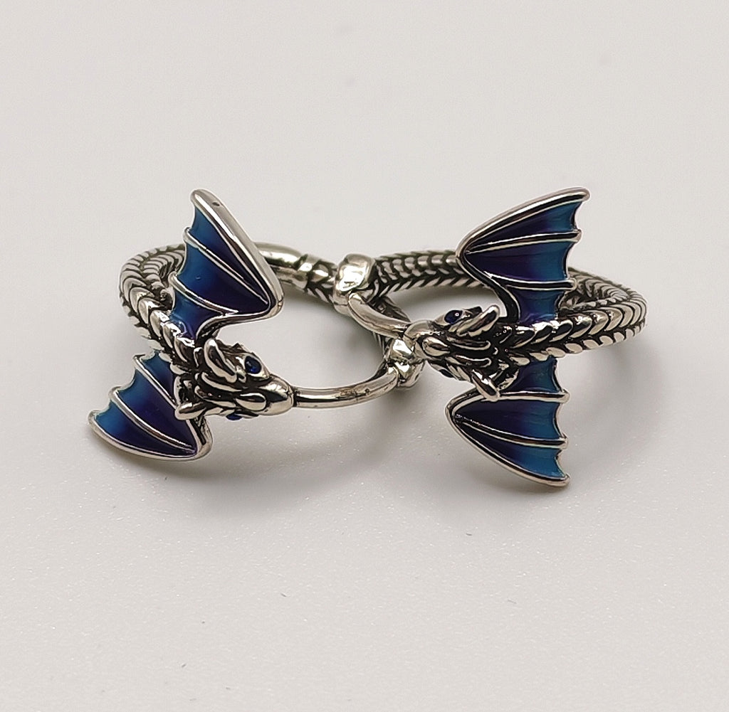 Close-up of sterling silver dragon hoop earring showing blue enamel wing detail