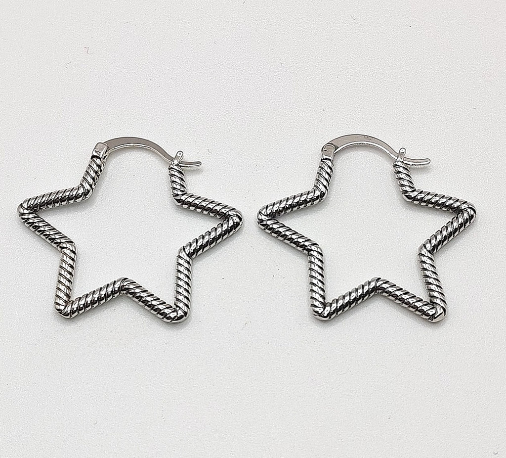 Open star-shaped sterling silver hoop earrings on white background