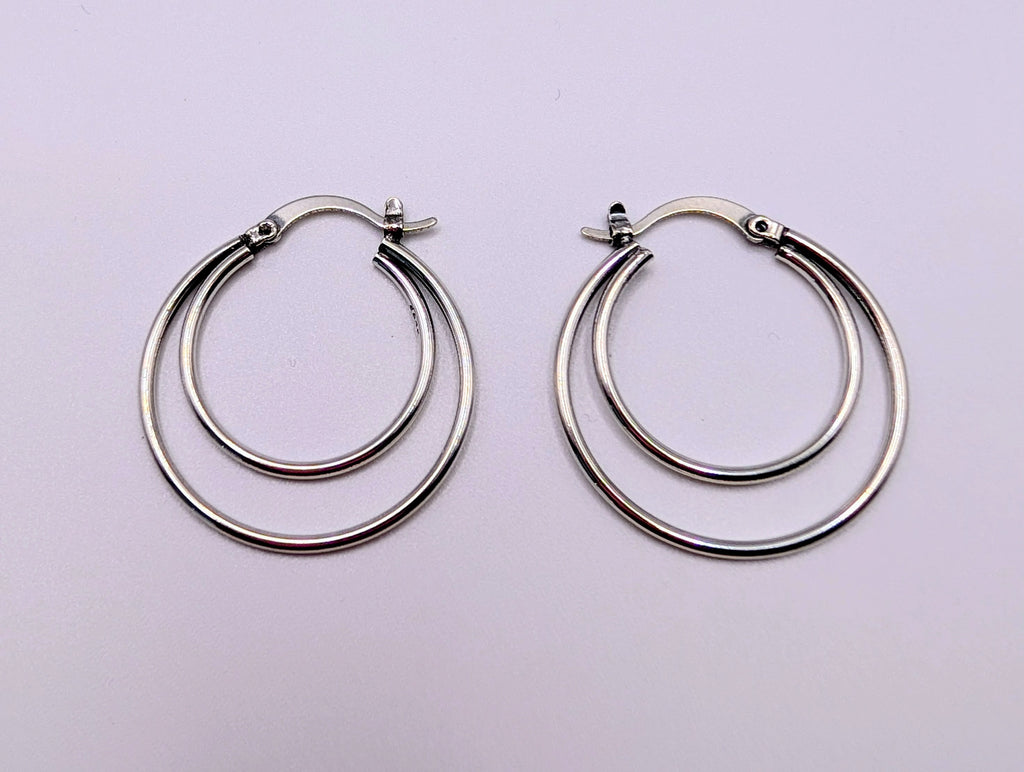 Back view of sterling silver double hoop earrings showing the stud-and-latch fastening.