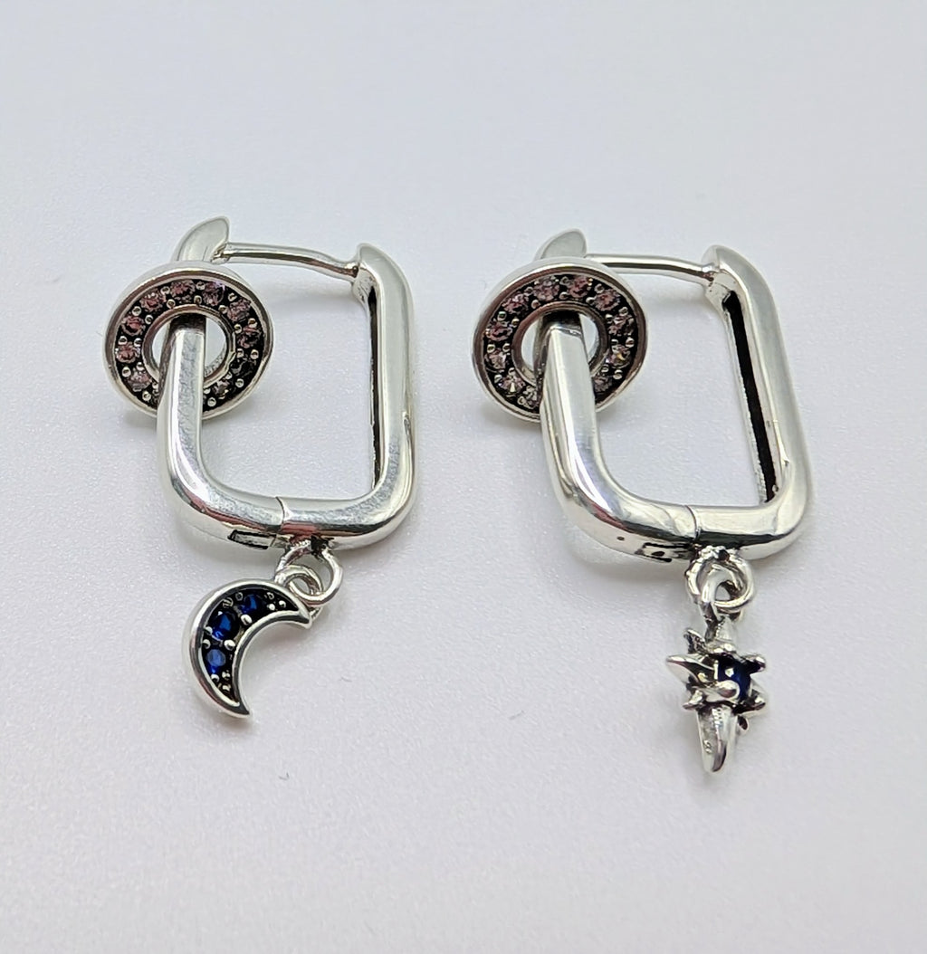 Sterling silver mismatched sun and moon hoop earrings with blue stones