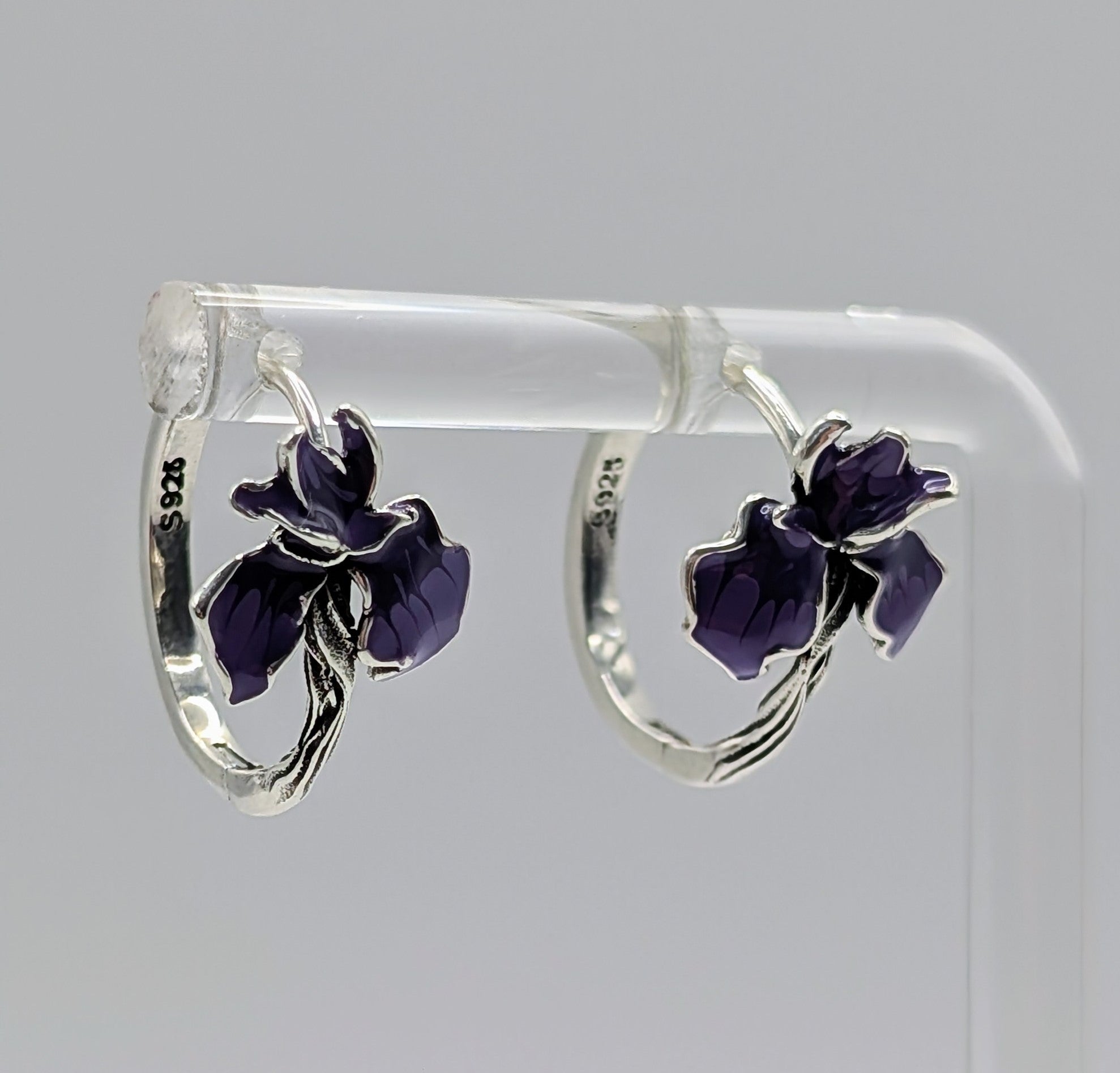 Sterling silver hoop earrings with purple enamel iris flower charms.