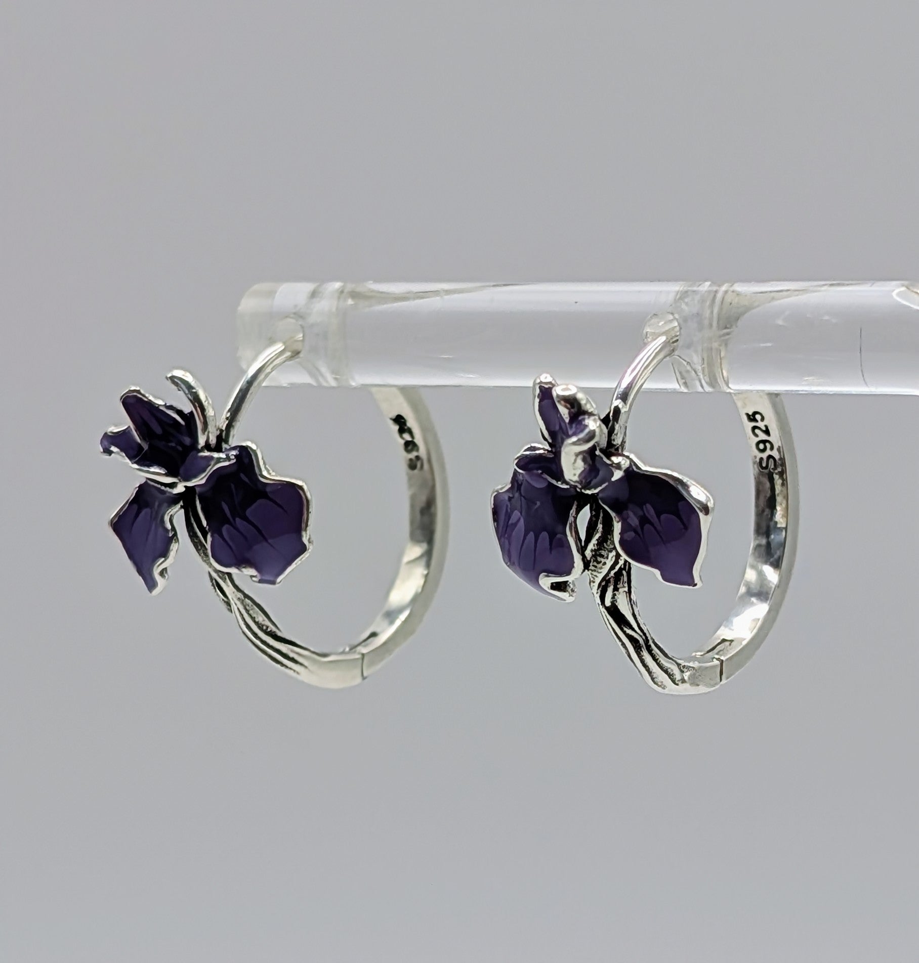 Pair of sterling silver floral hoop earrings with purple enamel flowers