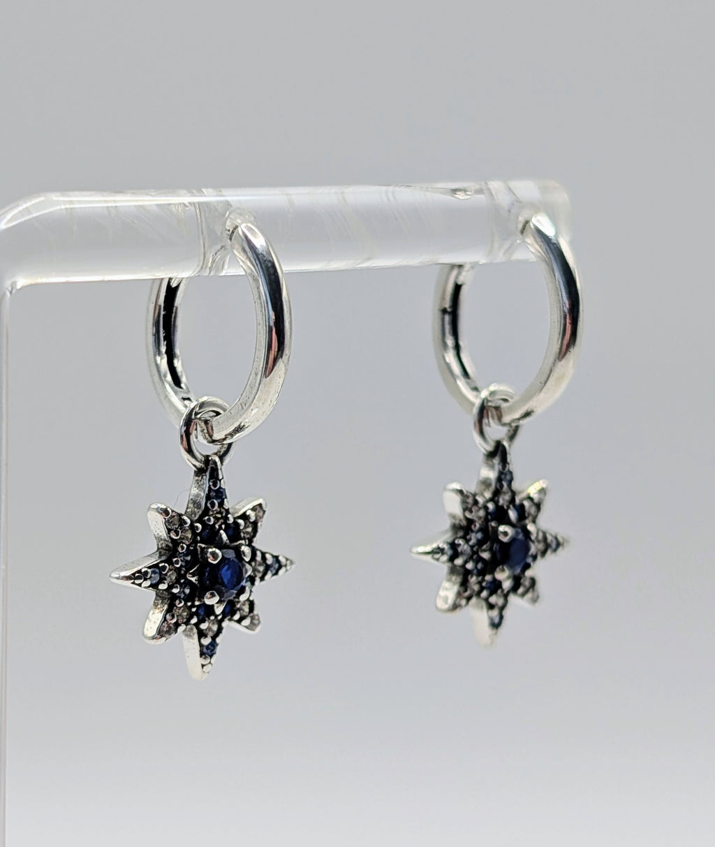 Elegant sterling silver hoop earrings with star-shaped zirconia pendant