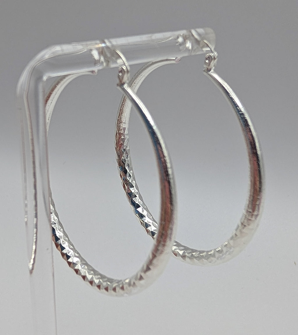 Sterling silver diamond-cut hoop earrings with textured finish