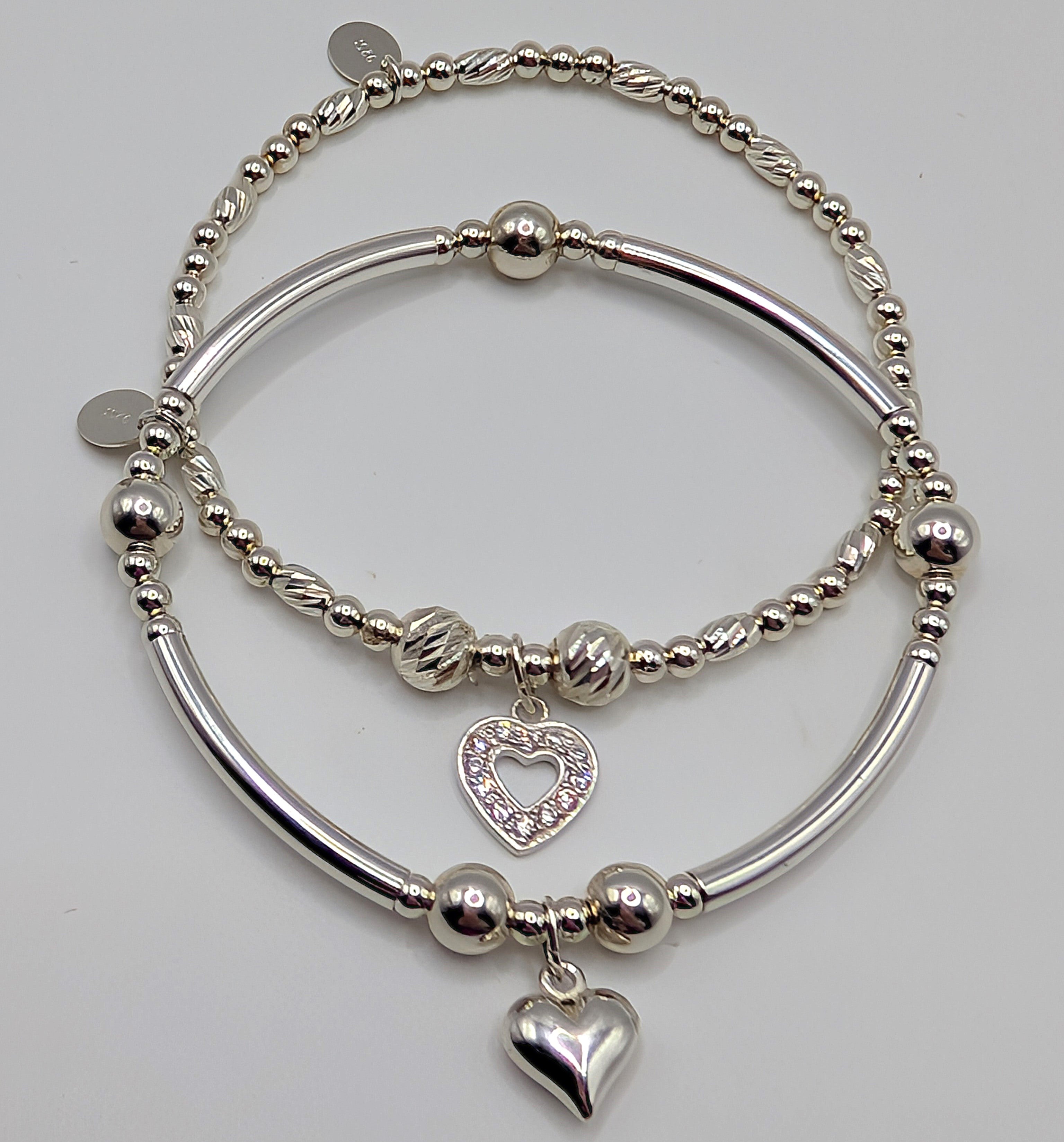 Set of two pretty sterling silver stretch handmade bracelets with heart charms
