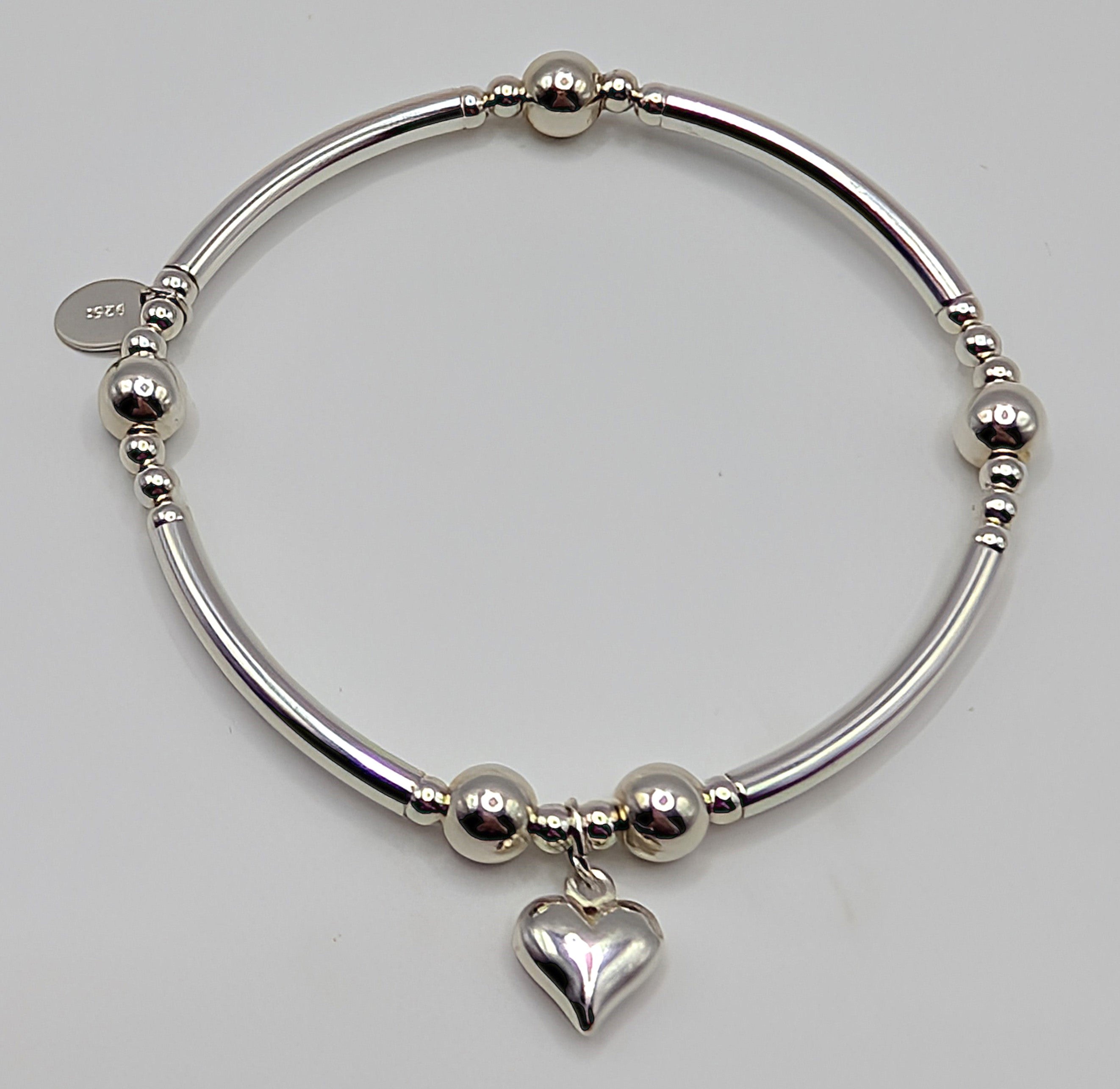 Set of two pretty sterling silver stretch handmade bracelets with heart charms
