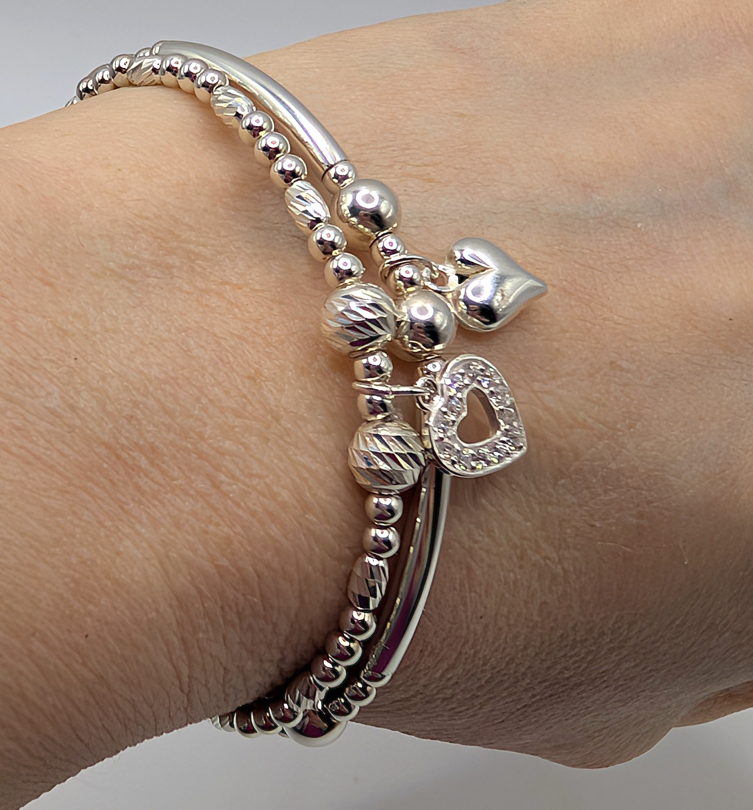 Set of two pretty sterling silver stretch handmade bracelets with heart charms