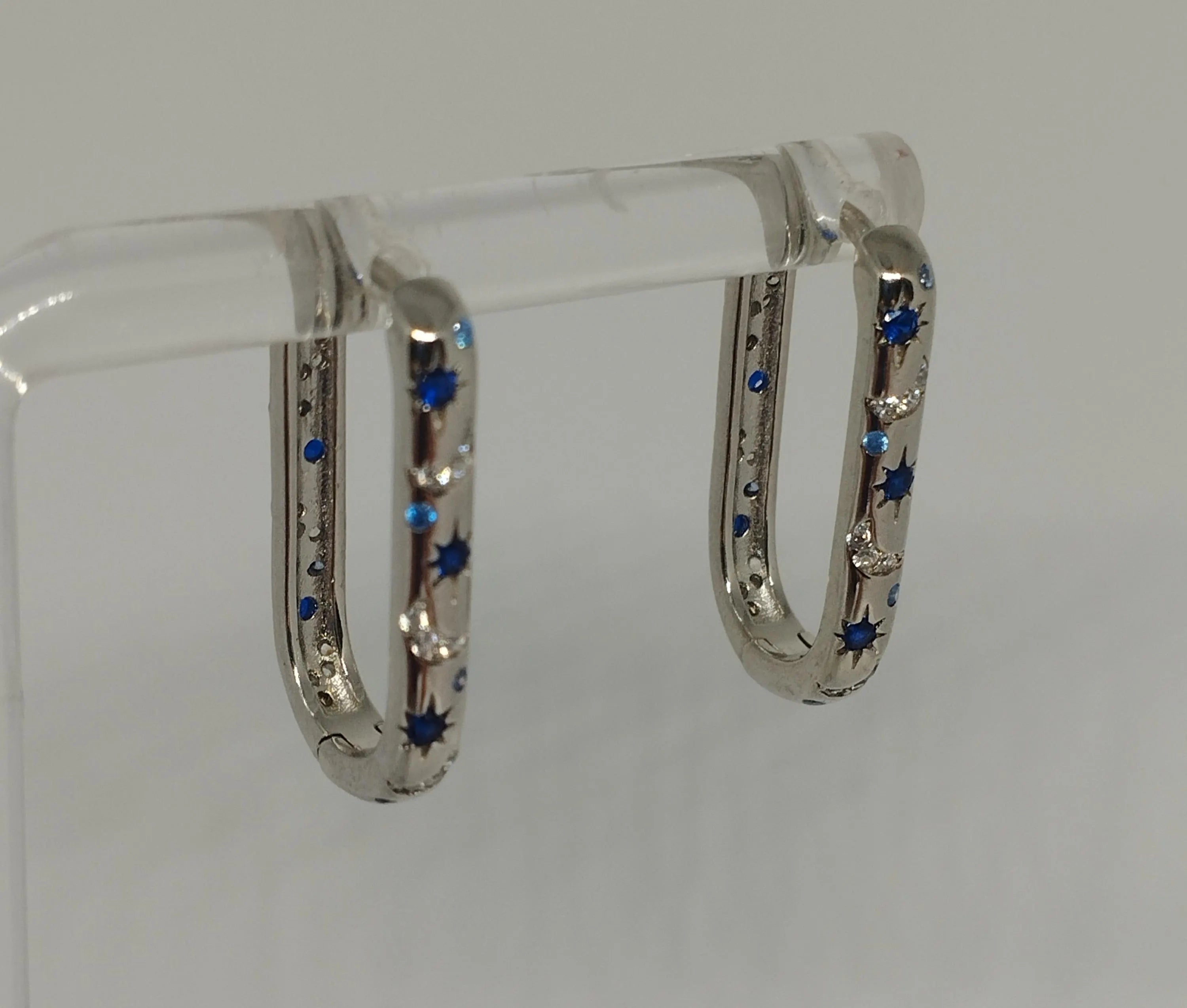 Sterling Silver Oblong Hoop Earrings with Moon Star Pattern And Blue Clear Zirconia Stones
