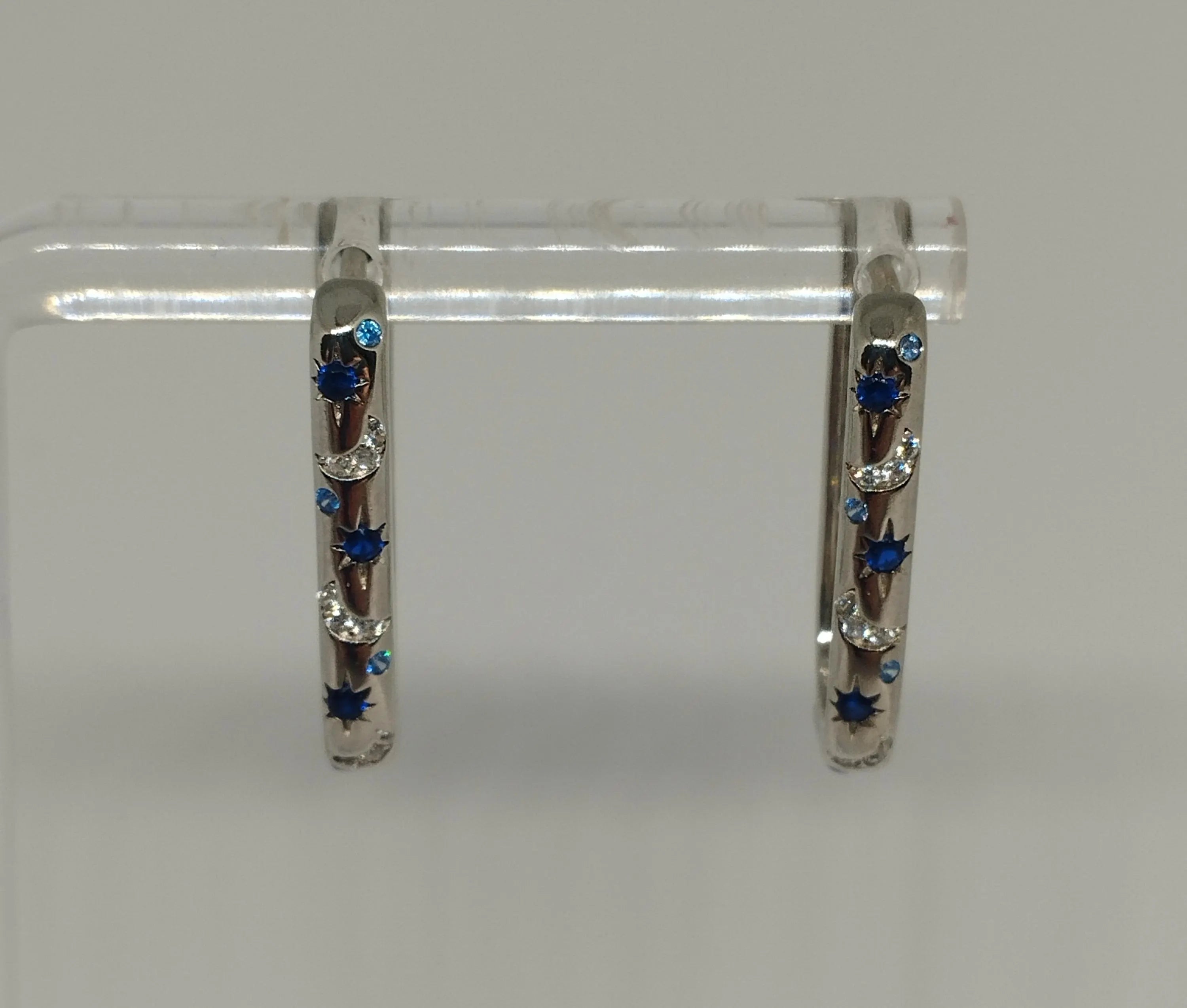 Sterling Silver Oblong Hoop Earrings with Moon Star Pattern And Blue Clear Zirconia Stones